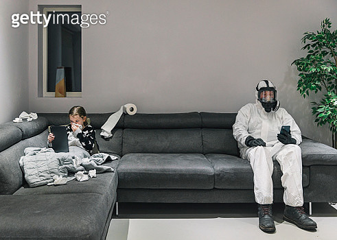 Young girls got the flu. Dad's in his full protective gear on other end of the sofa! - gettyimageskorea